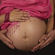 close-up-of-pregnant-bell-with-two-sets-of-hands-wrapped-around