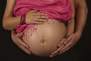 close-up-of-pregnant-bell-with-two-sets-of-hands-wrapped-around