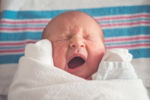 baby-wrapped-in-blanket-yawning