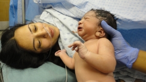 mother-being-shown-baby-post-caesarean