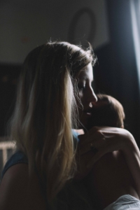 woman-holding-baby-in-the-dark